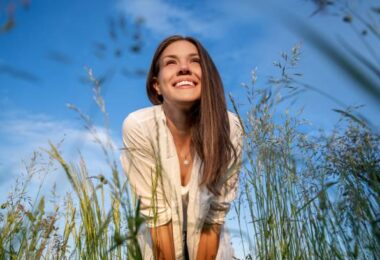 Low angle view portrait of a woman standing in the meadow Healthy Ways to Spend Your Free Time